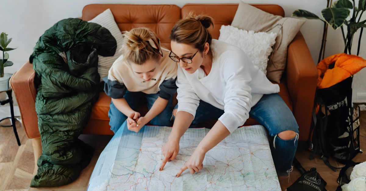 Parent and child looking at a map while planning a move together.
