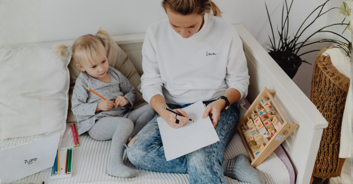 Parent writing best and worst case scenarios in a paper during a co-parenting decision-making exercise.