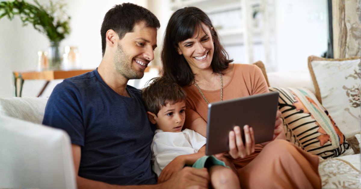 Co-parents using a digital communication system to stay organized while spending time with their child.