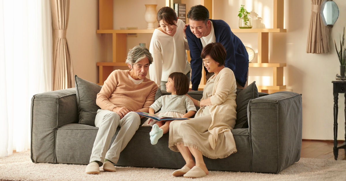 Extended family spending time together calmly with a young child on the couch.